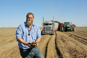 James Baker shows off a sample of the 2018 harvest as his crew digs Umatilla Russets.