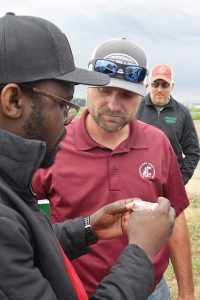 WSU’s Tim Waters shows a field day attendee a sample of a Lygus bug.