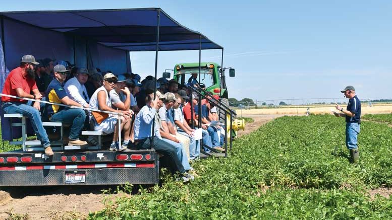 Attendees at the Miller Research Potato Pest Management Field Day inspect test plots as Jeff Miller explains what they are seeing.