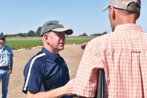 Jeff Miller shares some insight with an attendee at the annual Miller Research Potato Pest Management Field Day.