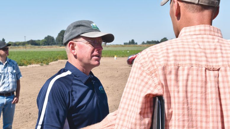 Jeff Miller shares some insight with an attendee at the annual Miller Research Potato Pest Management Field Day.