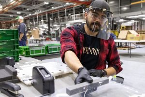 Jose Martinez, assembles protective face shields for health-care workers at the John Deere Seeding factory in Moline, Ill.