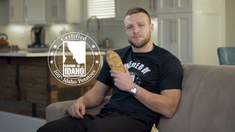 Taysom Hill holding a potato