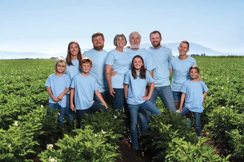 The Mitchell family farms 2,400 acres including 1,000 acres of potatoes, mostly for the fresh market. Pictured in front, from left, are Kenley Mitchell, Parker Mitchell, Madeline Mitchell and Sophia Mitchell. In the back, from left, are Gina Mitchell, Clay Mitchell, Glena Mitchell, Mike Mitchell, Tyler Mitchell and Melissa Mitchell. Photo courtesy Vibrant Valley Photography