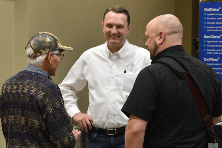 Jamie Higham (center), Idaho Potato Commission President/CEO visits with attendees at the Idaho Potato Conference.